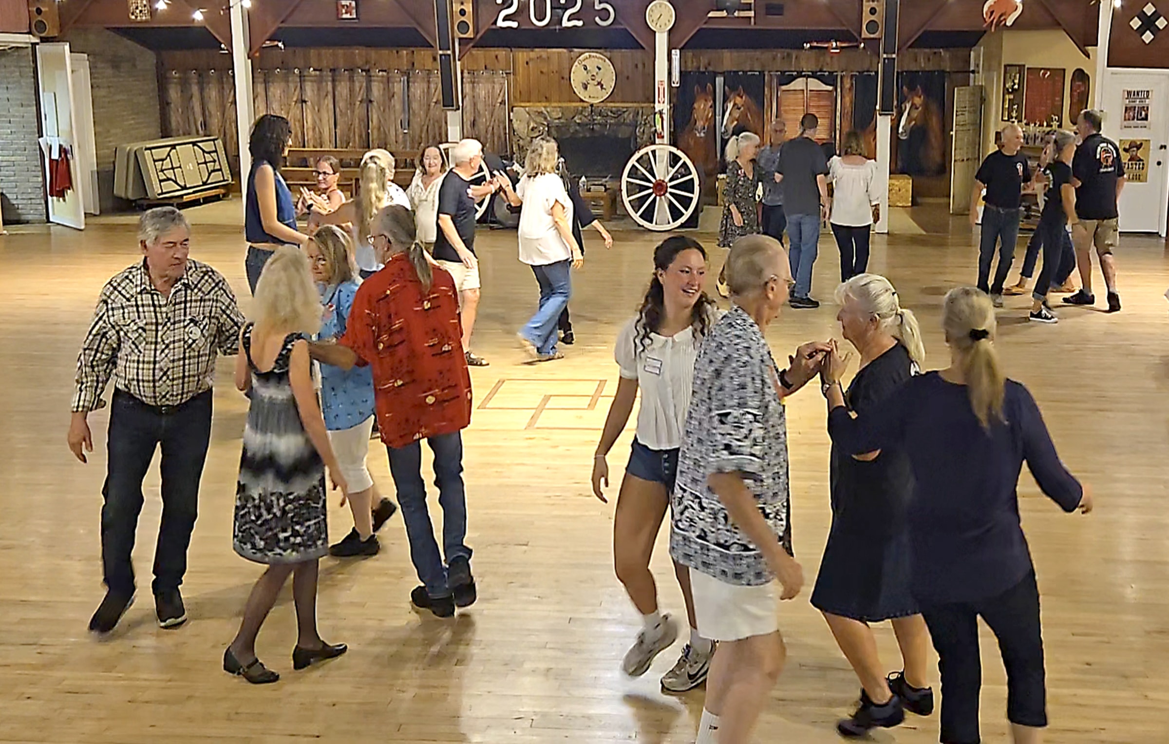 Square dancers performing a left-hand star figure in a rustic western hall in Roseburg, Oregon