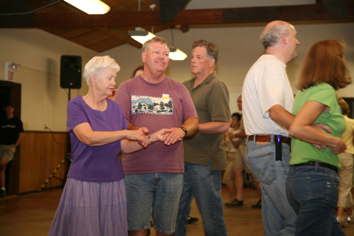 Community square dance program with couples dancing in a hall in Northern California