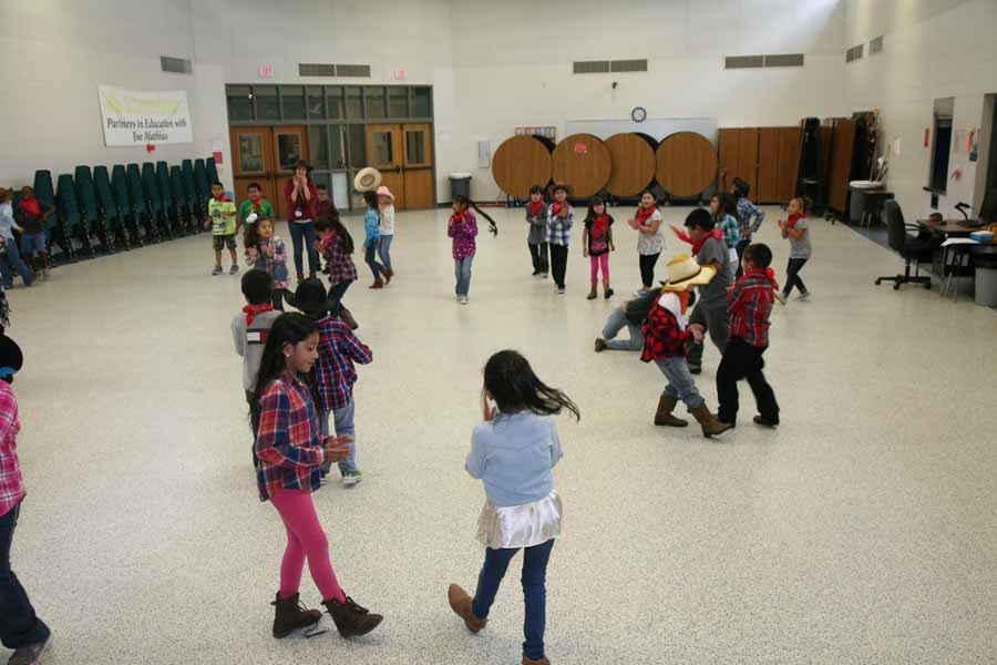 Group dancing La Raspa at a community dance event