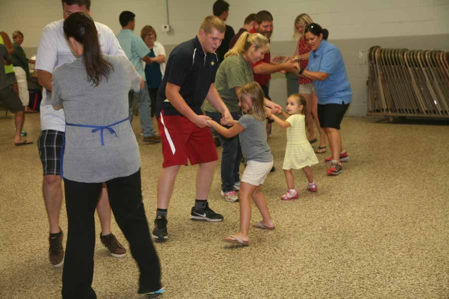 Group dancing the Patty Cake Polka at a barn dance event
