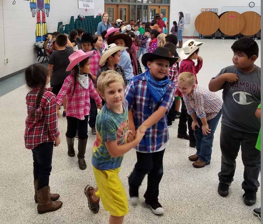 Children dancing at western themed school event